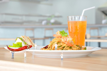 Miniature people are serving food