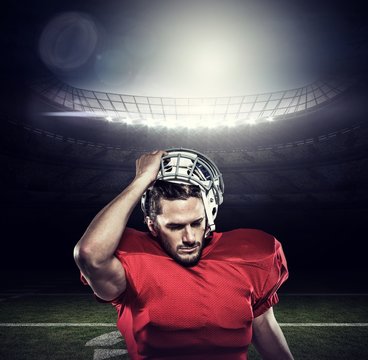Composite image of american football player in removing helmet