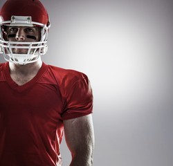 Composite image of american football player looking at camera