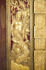 Carved wooden gate at the temple in Luang Prabang, Laos.