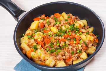 stewed potato with minced meat in a frying pan