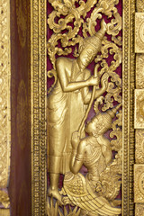 Carved wooden gate at the temple in Luang Prabang, Laos.