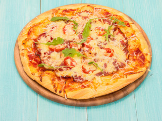 Delicious pizza served on wooden plate