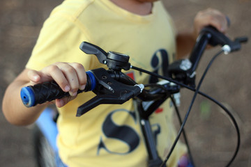 Prompt to start / A  kid holding his bike carefully prompting to ride 