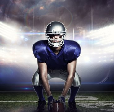 Composite image of american football player with ball crouching