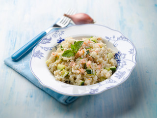 Fototapeta na wymiar risotto with fresh salmon and zucchinis, selective focus