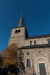 Fototapeta na wymiar protestant church with tower in Hilden before blue sky