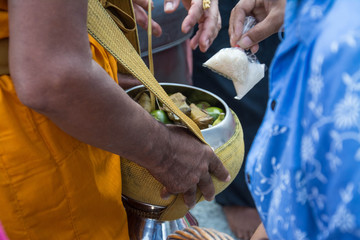  Buddhist monks are given food offering from people for End of Buddhist Lent Day