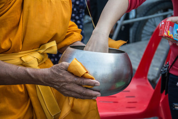  Buddhist monks are given food offering from people for End of Buddhist Lent Day