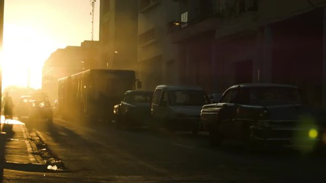 Sunset glow silhouettes on Havana busy street