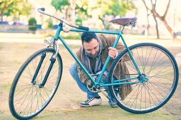 Fototapeta na wymiar Man checking the chain an antique bicycle