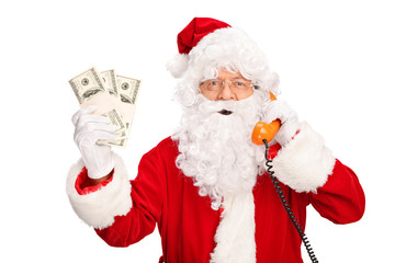 Santa Claus talking on phone and holding money