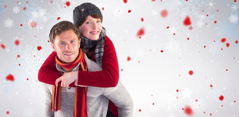 Composite image of man giving girlfriend piggy back