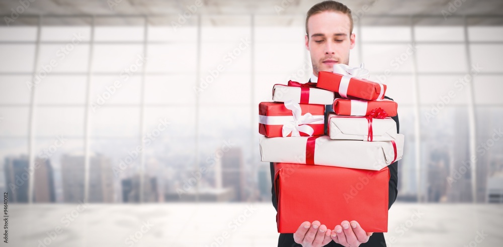 Poster Composite image of concentrated businessman holding gift