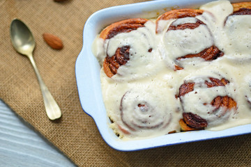 Fresh cinnamom rolls in ceramic baking dish closeup