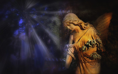 Fototapeta premium Majestic view of statue of golden angel illuminated by light aga