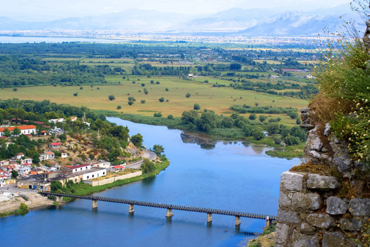 Pandoramic view to Shkoder town and the bridge over the blue river  in the north of Albania. Shot on a sunny summer day from top of Rosafa Castle.