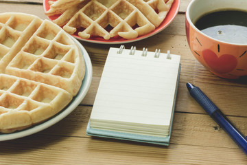 Coffee break with blank notebook on the wooden table - Vintage Filter Effect