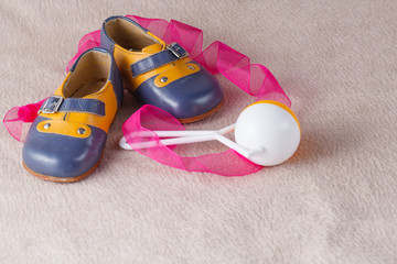 Baby shoes on soft background
