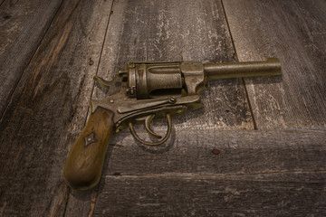 Gun abd Dark Brown Wooden Background
