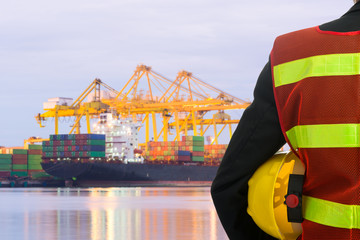 Hand or arm of engineer hold yellow plastic helmet