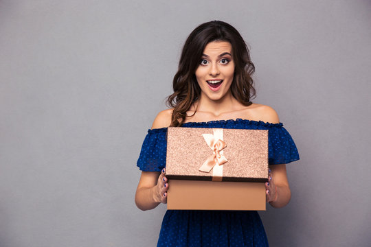 Happy woman opening gift box