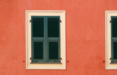 Fototapeta na wymiar decorative wooden window shutters closed on the exterior wall
