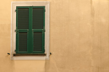 aged wooden window shutters on an old exterior wall