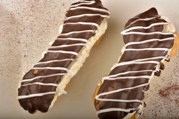 Tasty chocolate eclair and cream