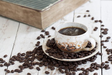 Coffee cup Beans and Book on White Wooden