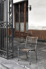 Fototapeta na wymiar Vintage wooden and iron chair in a porch.