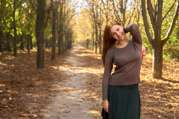 happy woman in the autumn park