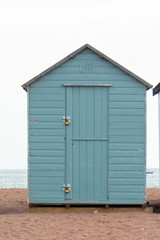 A blue green wooden beach hut in Teignmouth, Devon, Engla