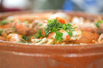 shrimps with rice and herbs in ceramic dish