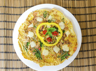 Spinach chili and pepper omelette.A spinach, chili, mint and pepper omelette in a dish in white background. A healthy diet meal omelet.