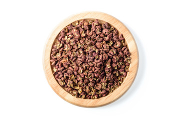 dry pink pepper in the wooden plate