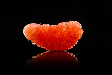 Grapefruit slice on black background