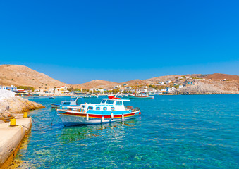 Obraz premium traditional fishing boats docked in the port of Pserimos island in Greece