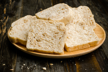 Whole wheat bread on wooden plate