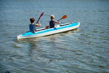 Young people in canoes. Family holiday.