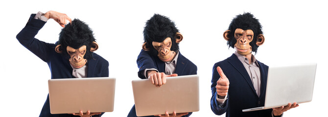 Happy monkey man holding a laptop © luismolinero