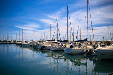 Fototapeta na wymiar Stock Photo beauty Harbor Yacht Club with glazed clear sea and blue clouds