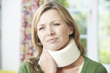 Woman Wearing Surgical Collar In Pain - obrazy, fototapety, plakaty