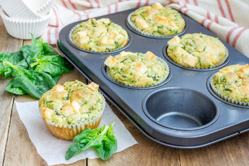 Freshly baked snack muffins with spinach and feta cheese