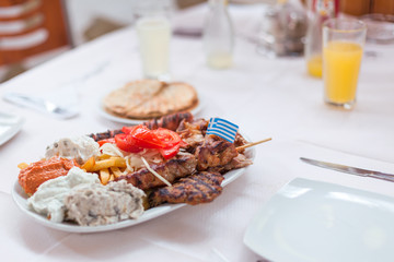 Greek menu with four types of grilled meat