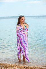little girl on beach with pink scarf