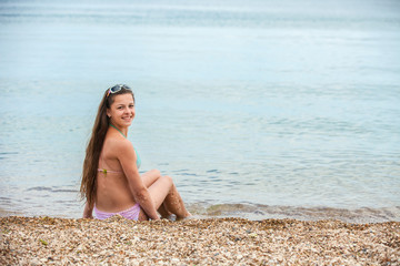 Fototapeta na wymiar Happy teen girl having fun in the sea