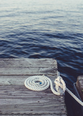 Rope coiled on an old weathered dock