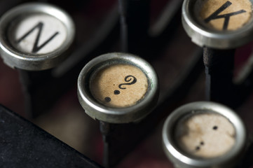 A close-up of question mark key on an old typewriter