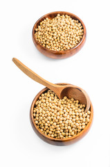 soybeans in wooden bowl with wooden spoon isolated on white background..